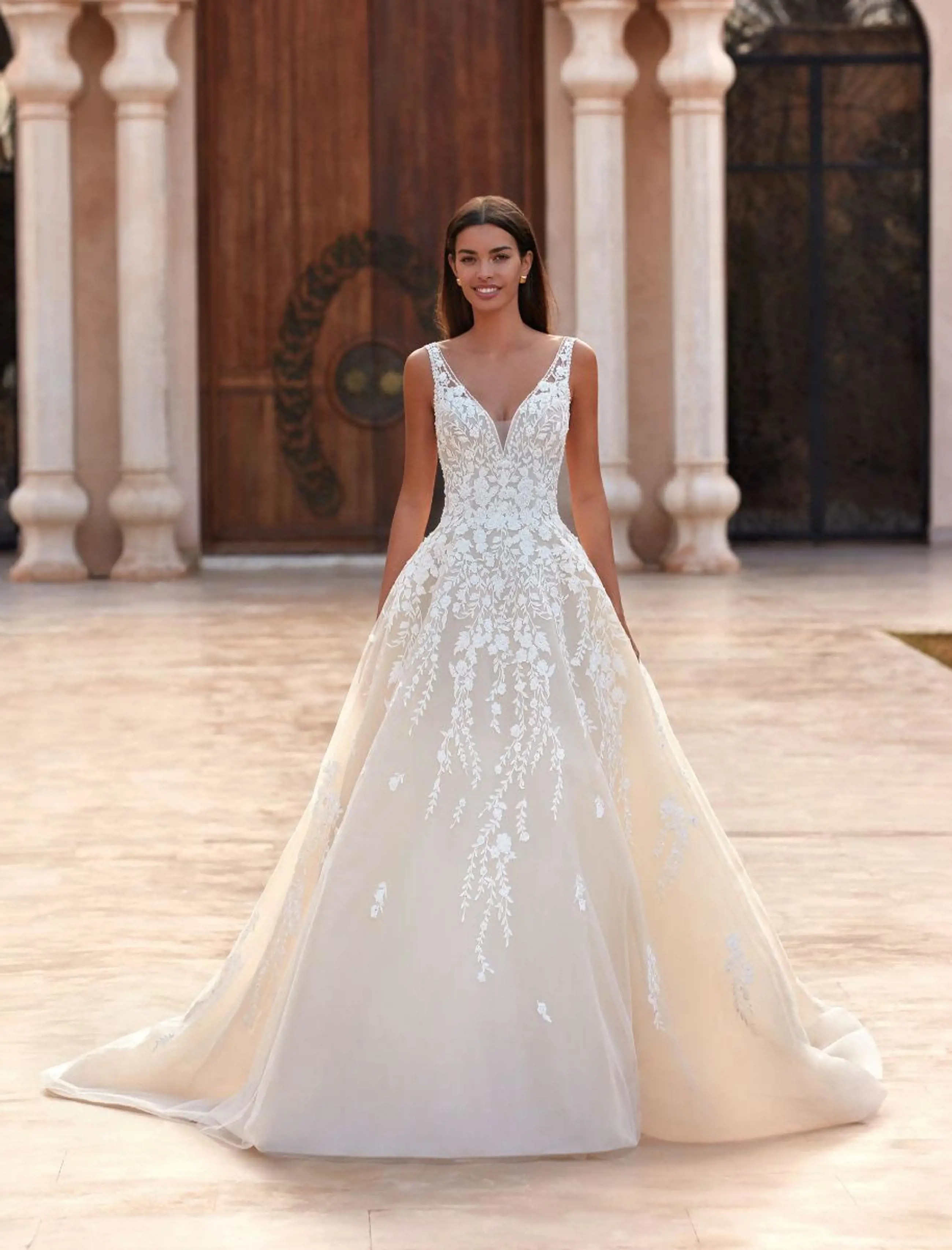 Model wearing a white gown by Demetrios
