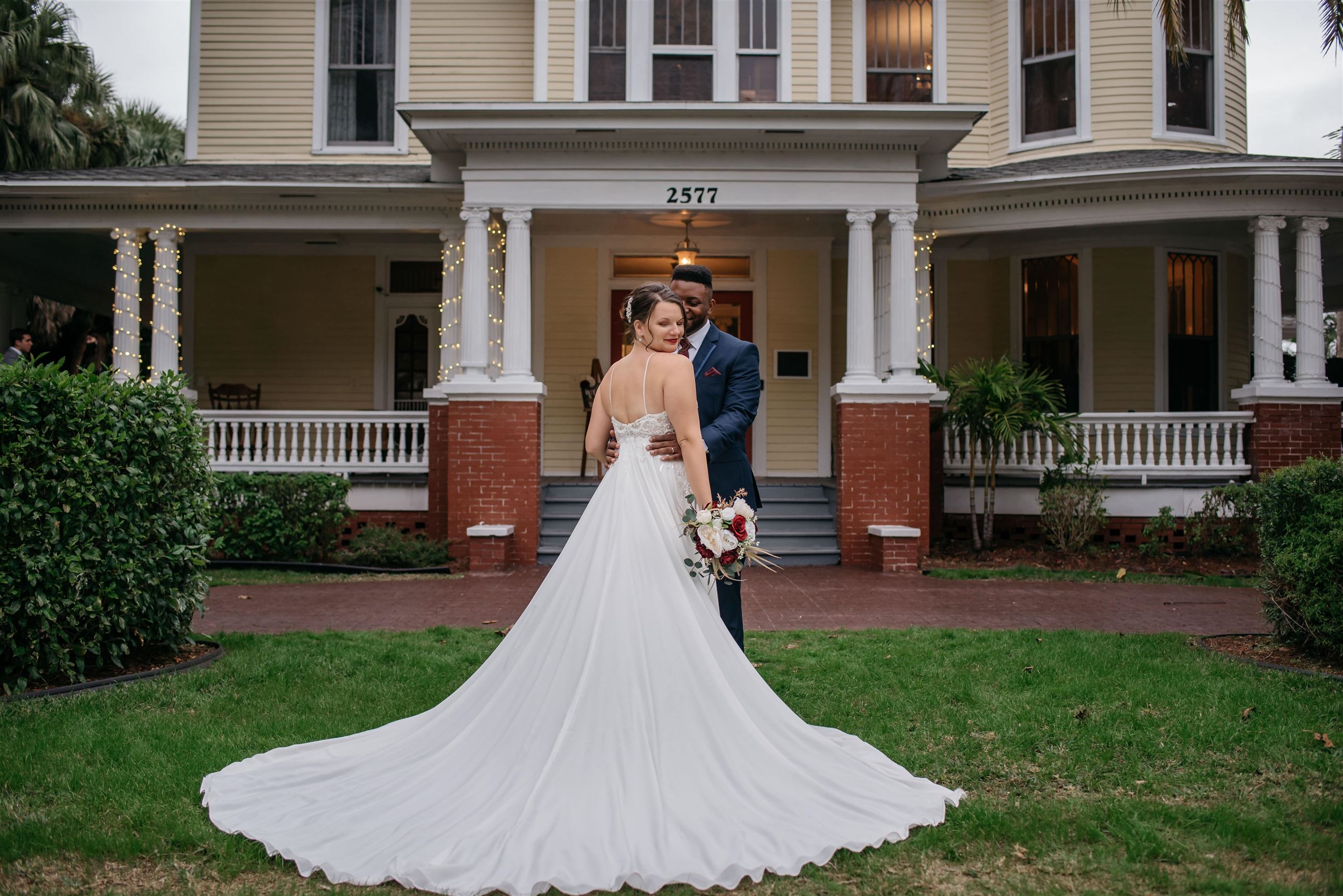 Сouple wearing a white gown and a black suit